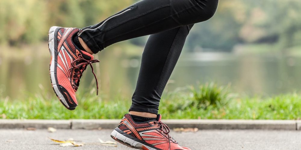Close-up-of-young-running-in-park-womans-feet Close-up-of-young-running-in-park-womans-feet